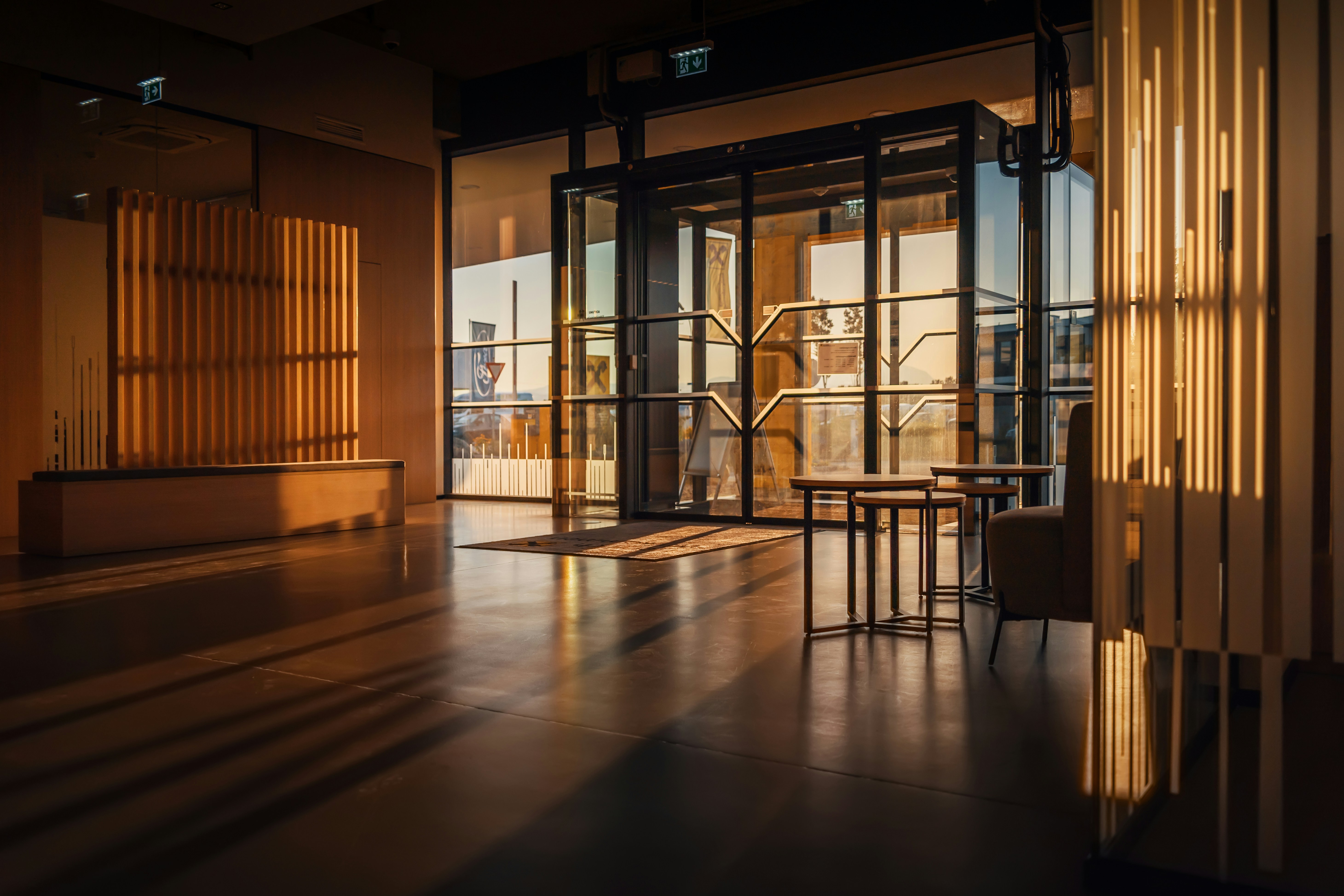 The sunlit entrance and reception of a modern building at golden hour